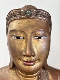 A very large Burmese mica-inlaid gilt-lacquered wooden Mandaly Buddha, 20th C.
