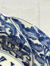 Eleven Chinese blue and white gadrooned 'Flowers and Peacocks' plates, Kangxi