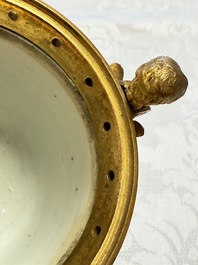 A pair of gilt-bronze-mounted Chinese famille rose capucine-ground vases and a covered bowl, Qianlong