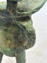 A Chinese archaic bronze wine vessel with Taotie design, Jue 爵, late Shang