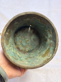 A Chinese archaic bronze wine vessel with Taotie design, Zun 尊, late Shang
