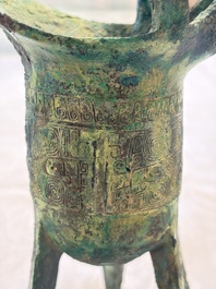 A Chinese archaic bronze wine vessel with Taotie design, Jue 爵, late Shang