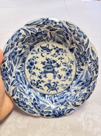 Eleven Chinese blue and white gadrooned 'Flowers and Peacocks' plates, Kangxi