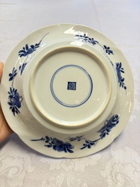 Eleven Chinese blue and white gadrooned 'Flowers and Peacocks' plates, Kangxi