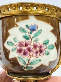 A pair of gilt-bronze-mounted Chinese famille rose capucine-ground vases and a covered bowl, Qianlong