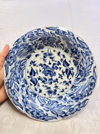 Eleven Chinese blue and white gadrooned 'Flowers and Peacocks' plates, Kangxi