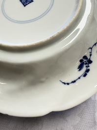 Eleven Chinese blue and white gadrooned 'Flowers and Peacocks' plates, Kangxi