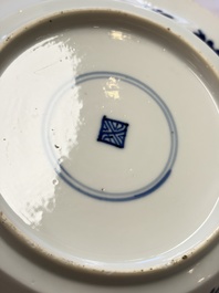 Eleven Chinese blue and white gadrooned 'Flowers and Peacocks' plates, Kangxi