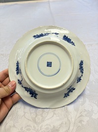 Eleven Chinese blue and white gadrooned 'Flowers and Peacocks' plates, Kangxi