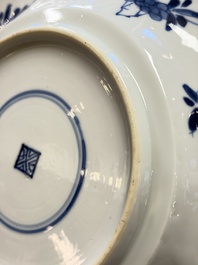 Eleven Chinese blue and white gadrooned 'Flowers and Peacocks' plates, Kangxi