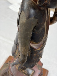 A rare Chinese gilt-lacquered bronze Buddha standing on a lotus throne, Ming