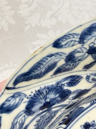 Eleven Chinese blue and white gadrooned 'Flowers and Peacocks' plates, Kangxi