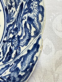 Eleven Chinese blue and white gadrooned 'Flowers and Peacocks' plates, Kangxi