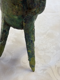 A Chinese archaic bronze wine vessel with Taotie design, Jue 爵, late Shang