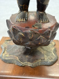 A rare Chinese gilt-lacquered bronze Buddha standing on a lotus throne, Ming