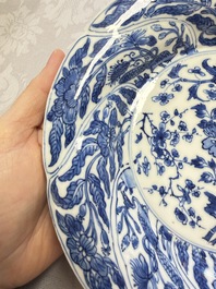 Eleven Chinese blue and white gadrooned 'Flowers and Peacocks' plates, Kangxi