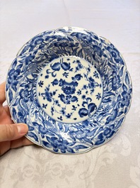 Eleven Chinese blue and white gadrooned 'Flowers and Peacocks' plates, Kangxi