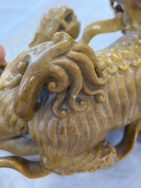 A fine Chinese soapstone group of Buddhist lions on wooden stand, 19th C.