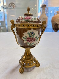 A pair of gilt-bronze-mounted Chinese famille rose capucine-ground vases and a covered bowl, Qianlong