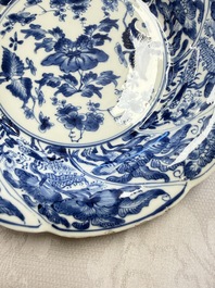 Eleven Chinese blue and white gadrooned 'Flowers and Peacocks' plates, Kangxi