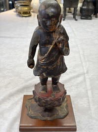 A rare Chinese gilt-lacquered bronze Buddha standing on a lotus throne, Ming