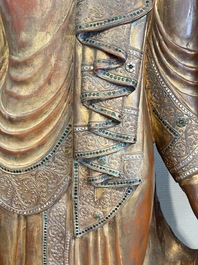 A very large Burmese mica-inlaid gilt-lacquered wooden Mandaly Buddha, 20th C.
