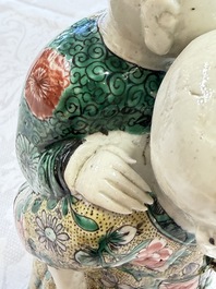 A pair of Chinese verte biscuit 'Piggyback Boys' groups, Kangxi