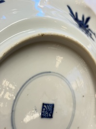 Eleven Chinese blue and white gadrooned 'Flowers and Peacocks' plates, Kangxi