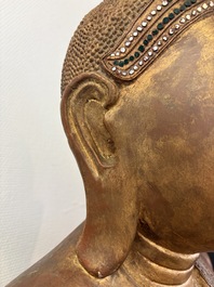 A very large Burmese mica-inlaid gilt-lacquered wooden Mandaly Buddha, 20th C.