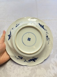 Eleven Chinese blue and white gadrooned 'Flowers and Peacocks' plates, Kangxi