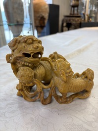 A fine Chinese soapstone group of Buddhist lions on wooden stand, 19th C.