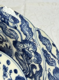 Eleven Chinese blue and white gadrooned 'Flowers and Peacocks' plates, Kangxi