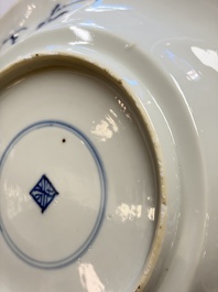 Eleven Chinese blue and white gadrooned 'Flowers and Peacocks' plates, Kangxi