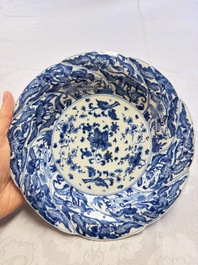 Eleven Chinese blue and white gadrooned 'Flowers and Peacocks' plates, Kangxi