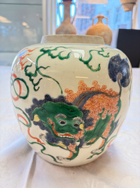 A fine Chinese famille verte 'Buddhist Lions' jar and a reticulated wooden cover, 19th C.