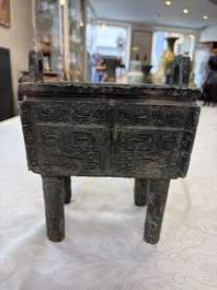 An inscribed Chinese archaic bronze food vessel with Taotie design, Ding 鼎, Western Zhou