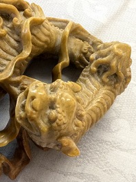 A fine Chinese soapstone group of Buddhist lions on wooden stand, 19th C.