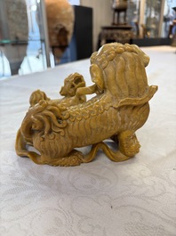 A fine Chinese soapstone group of Buddhist lions on wooden stand, 19th C.
