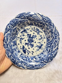 Eleven Chinese blue and white gadrooned 'Flowers and Peacocks' plates, Kangxi