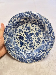 Eleven Chinese blue and white gadrooned 'Flowers and Peacocks' plates, Kangxi