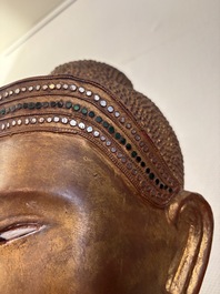 A very large Burmese mica-inlaid gilt-lacquered wooden Mandaly Buddha, 20th C.
