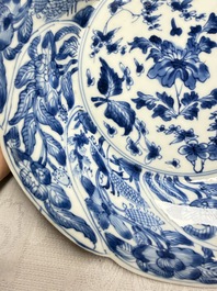 Eleven Chinese blue and white gadrooned 'Flowers and Peacocks' plates, Kangxi