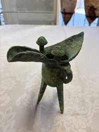A Chinese archaic bronze wine vessel with Taotie design, Jue 爵, late Shang