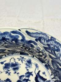 Eleven Chinese blue and white gadrooned 'Flowers and Peacocks' plates, Kangxi