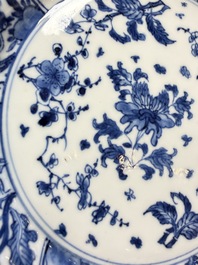 Eleven Chinese blue and white gadrooned 'Flowers and Peacocks' plates, Kangxi