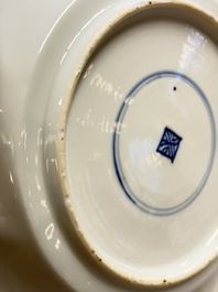 Eleven Chinese blue and white gadrooned 'Flowers and Peacocks' plates, Kangxi