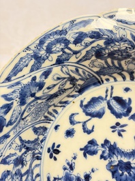 Eleven Chinese blue and white gadrooned 'Flowers and Peacocks' plates, Kangxi