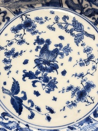 Eleven Chinese blue and white gadrooned 'Flowers and Peacocks' plates, Kangxi