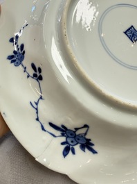 Eleven Chinese blue and white gadrooned 'Flowers and Peacocks' plates, Kangxi