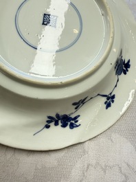 Eleven Chinese blue and white gadrooned 'Flowers and Peacocks' plates, Kangxi